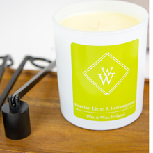 Load image into Gallery viewer, Hand poured soy candle with lime and lemongrass scent, handmade in Ireland by Wix & Wax.White candle jar with green label on a wooden surface with a candle snuffer and wick trimmer