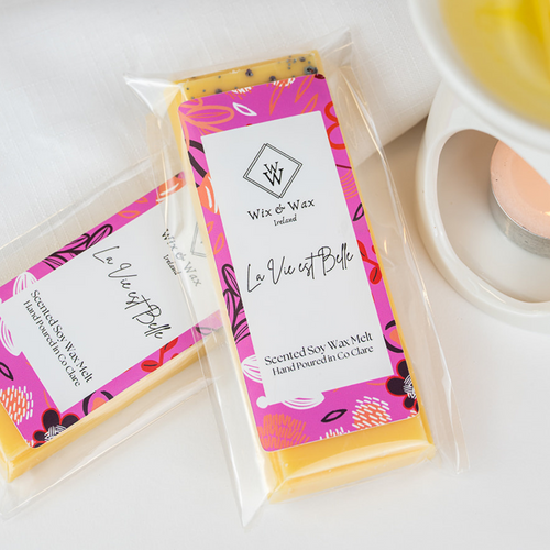 La Vie Est Belle wax melt by Wix and Wax – hand-poured soy blend with a sweet, floral perfume-inspired scent, presented in chic, eco-conscious packaging.